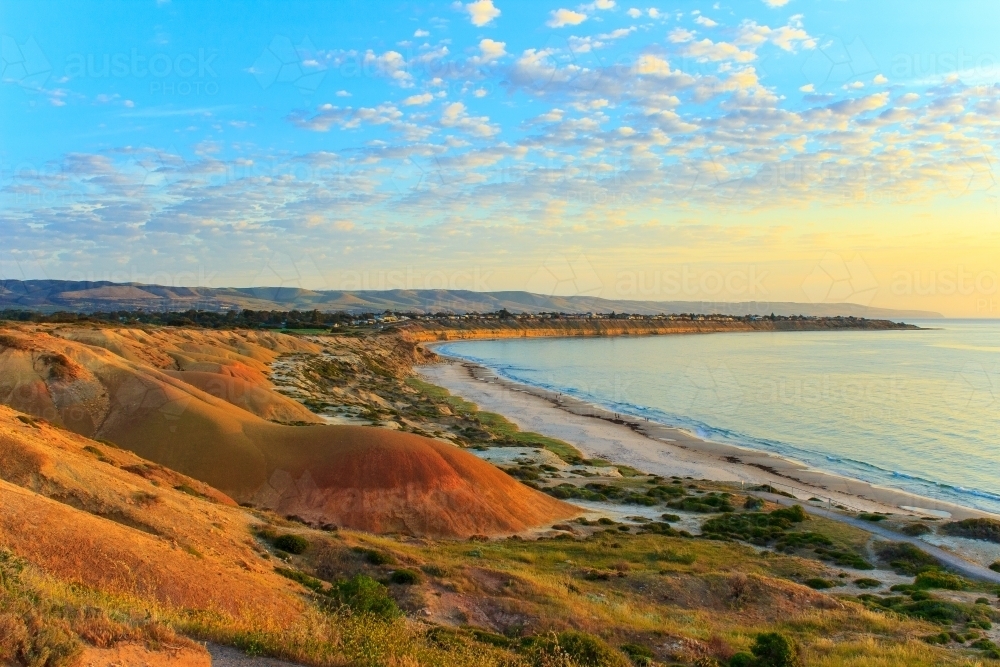 Horizontal shot of a hilly coastline at sunrise - Australian Stock Image