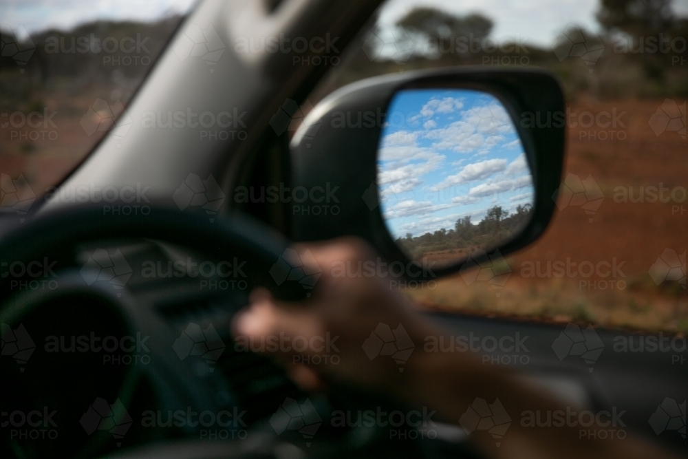 Horizontal shot of a road trip through wing mirror - Australian Stock Image