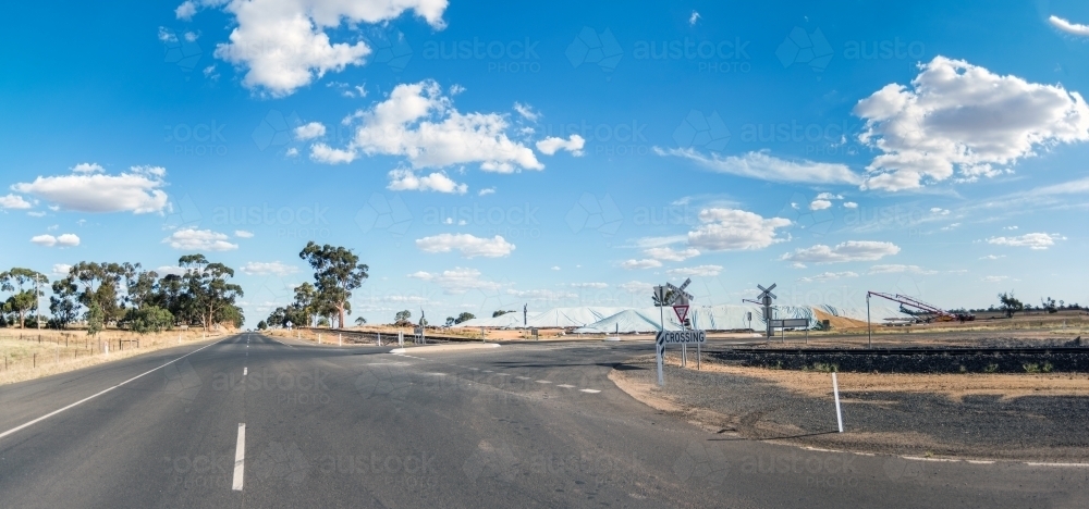 Horizontal shot of a rural road that leads to a turnoff. - Australian Stock Image