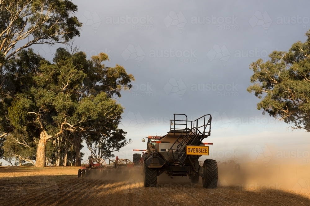 Horizontal shot of a tractor cultivating the field. - Australian Stock Image