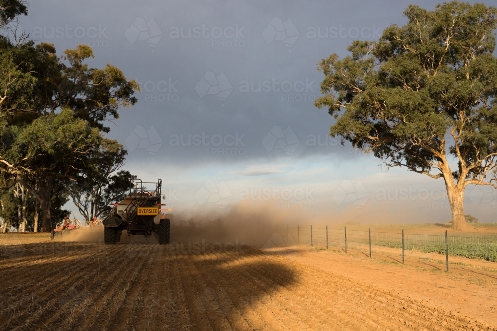 Horizontal shot of a tractor cultivating the field. - Australian Stock Image