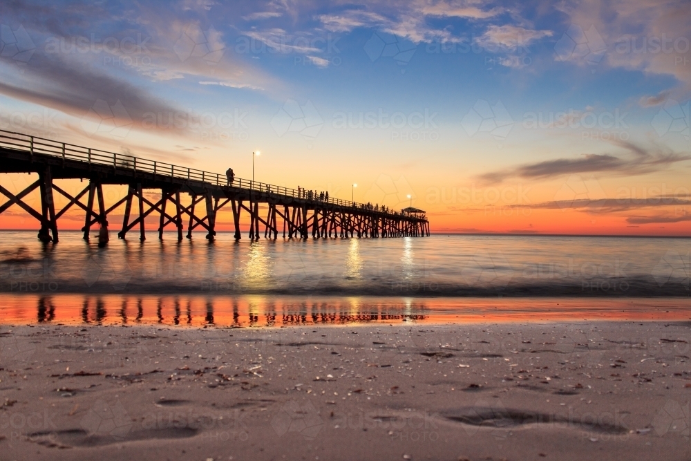 Horizontal shot of a wharf on the beach at sunset - Australian Stock Image