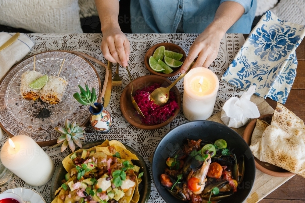 Horizontal shot of a woman's hand preparing a food in a bowl. - Australian Stock Image