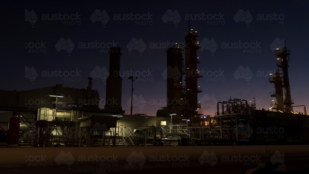 Horizontal shot of an industrial plant at night - Australian Stock Image