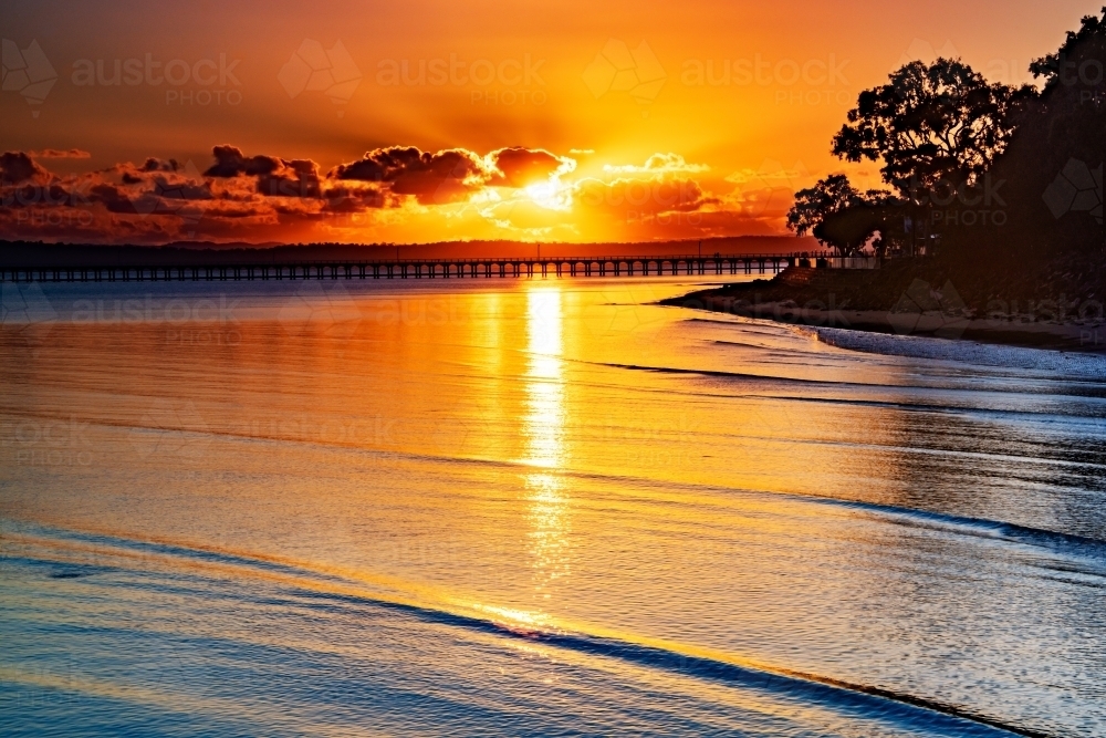 Horizontal shot of an ocean at sunrise - Australian Stock Image