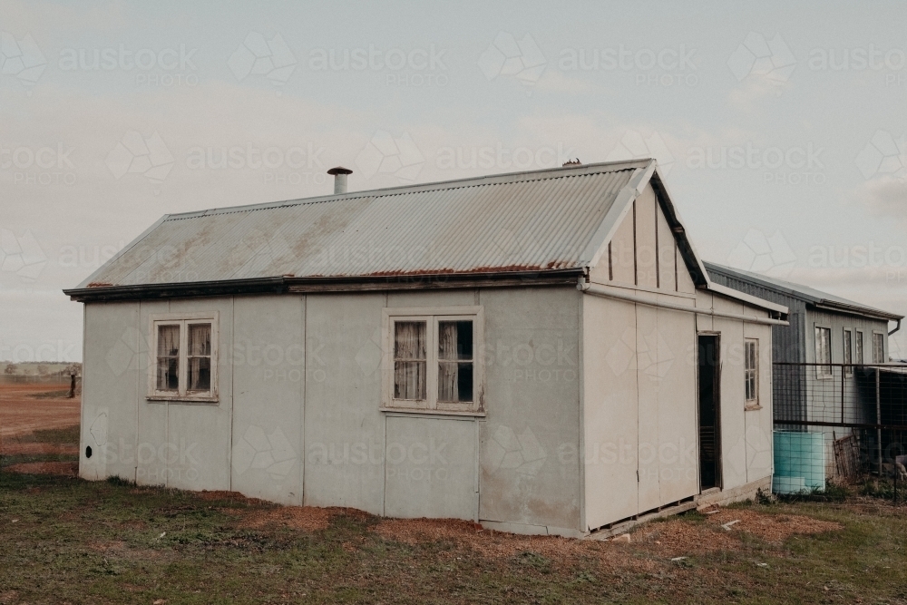 Horizontal shot of an old white farm outbuilding - Australian Stock Image
