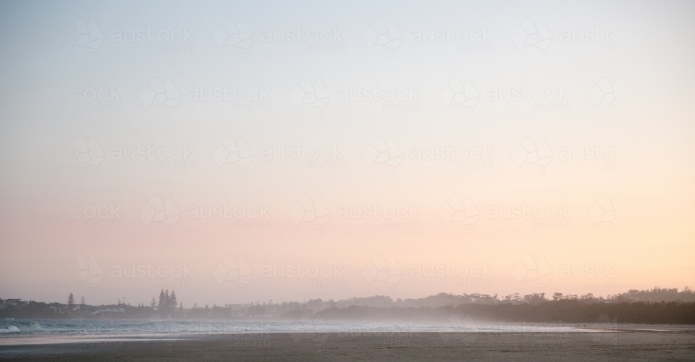 Horizontal shot of beach waves at sunset - Australian Stock Image