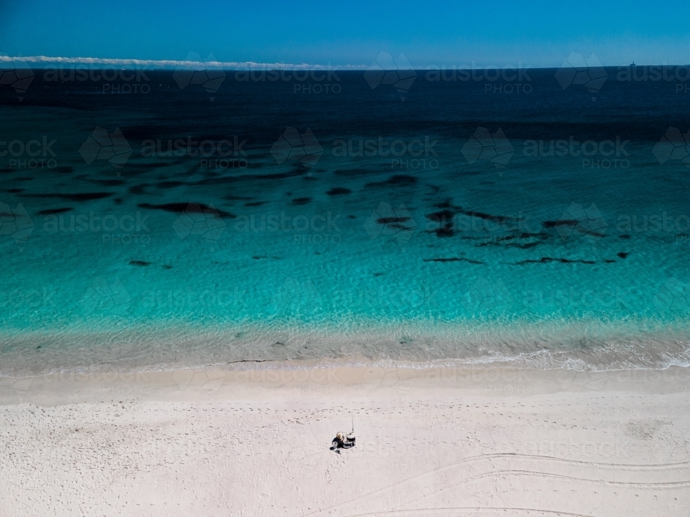horizontal shot of beach with objects on the white sand on a sunny day - Australian Stock Image