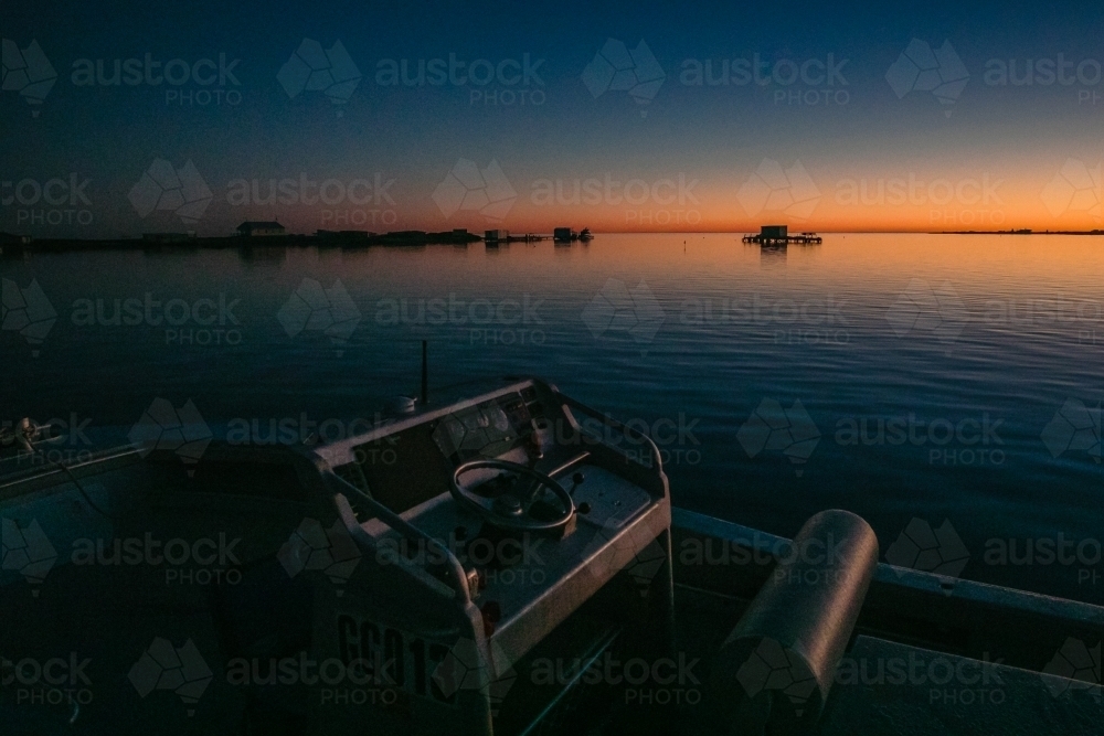 Horizontal shot of boats on the sea at sunset. - Australian Stock Image