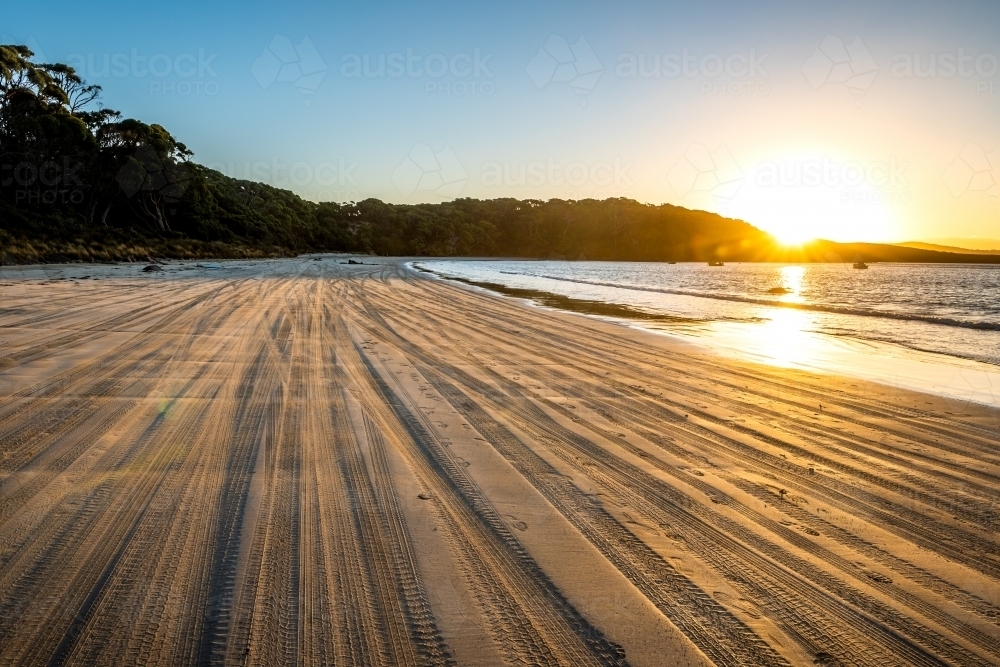 Horizontal shot of brown sand beach during sunset - Australian Stock Image