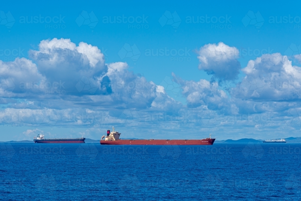 Horizontal shot of cargo ships in the sea - Australian Stock Image