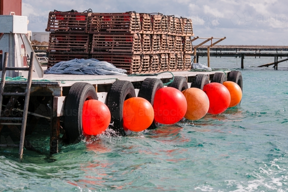 Horizontal shot of commercial cray fishing equipment on a jetty - Australian Stock Image