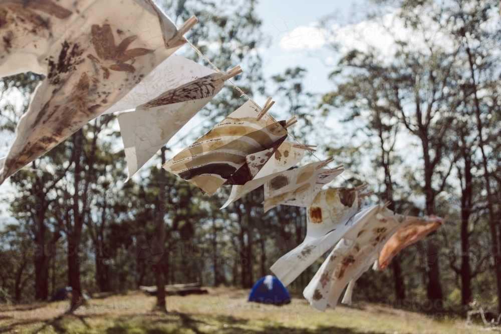 Horizontal shot of hand painted papers being dried up - Australian Stock Image