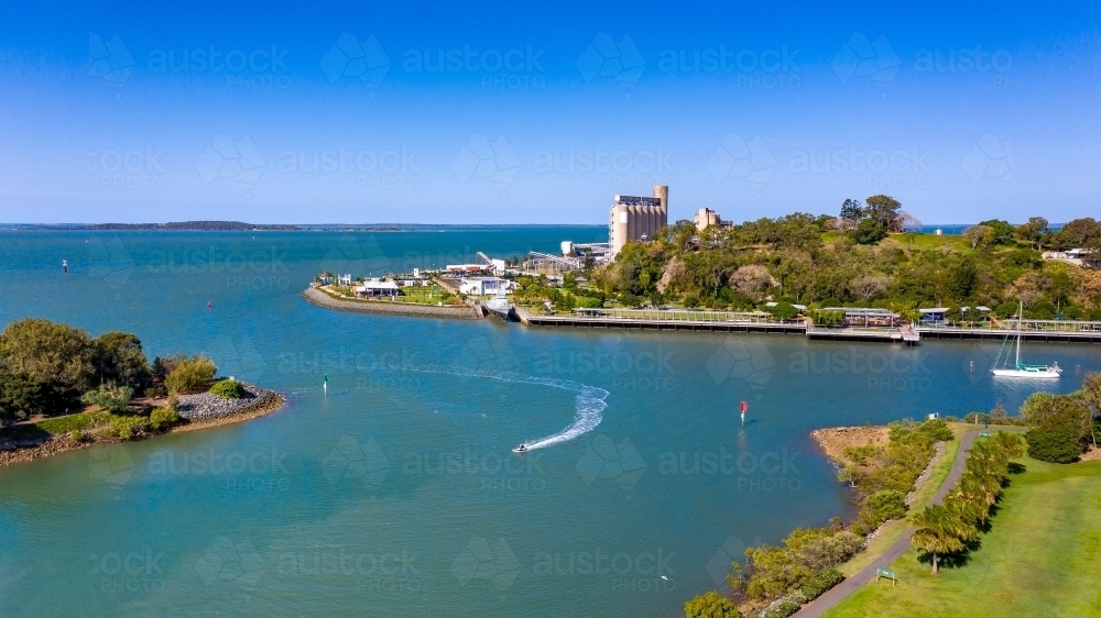 Horizontal shot of industry with boat in foreground - Australian Stock Image