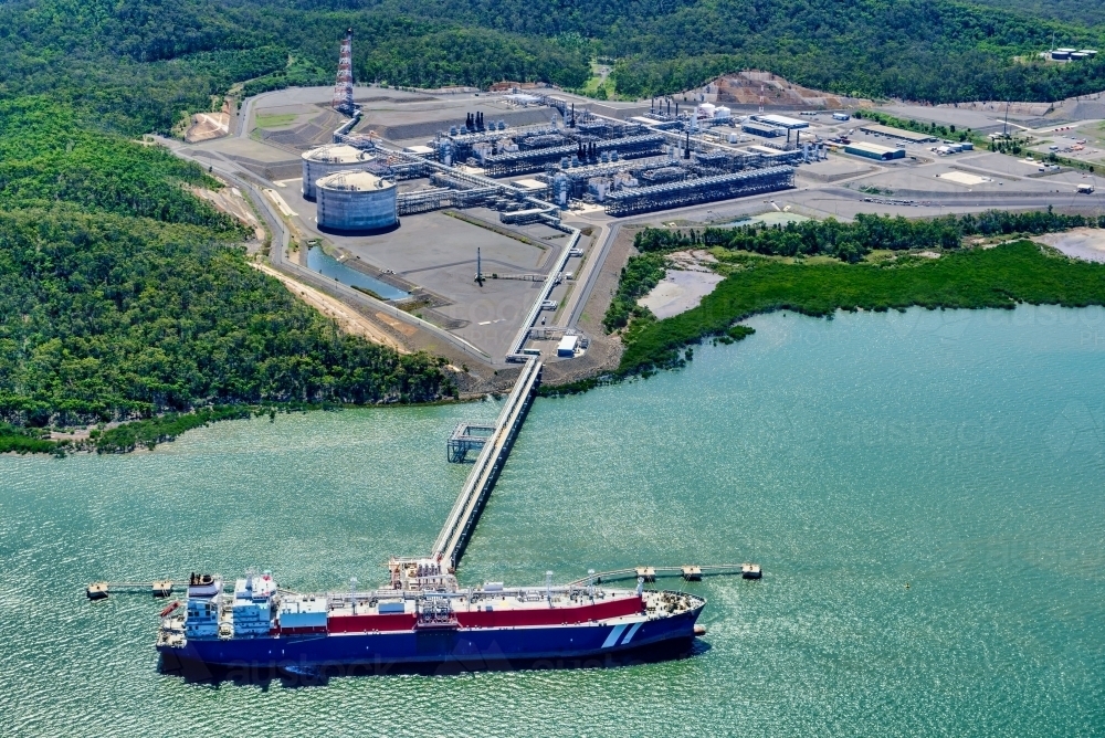 Horizontal shot of  liquified natural gas plant and LNG ship on Curtis Island, Queensland - Australian Stock Image