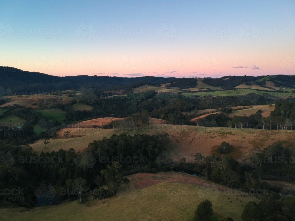 Horizontal shot of peak and mountain ranges at sunset - Australian Stock Image