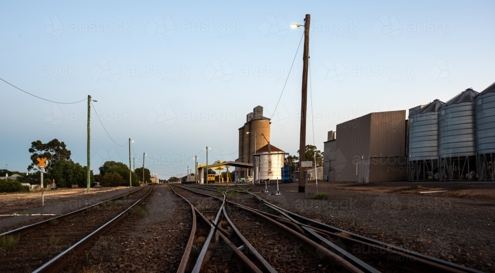 Horizontal shot of railway lines in farming land at beginning of day. - Australian Stock Image