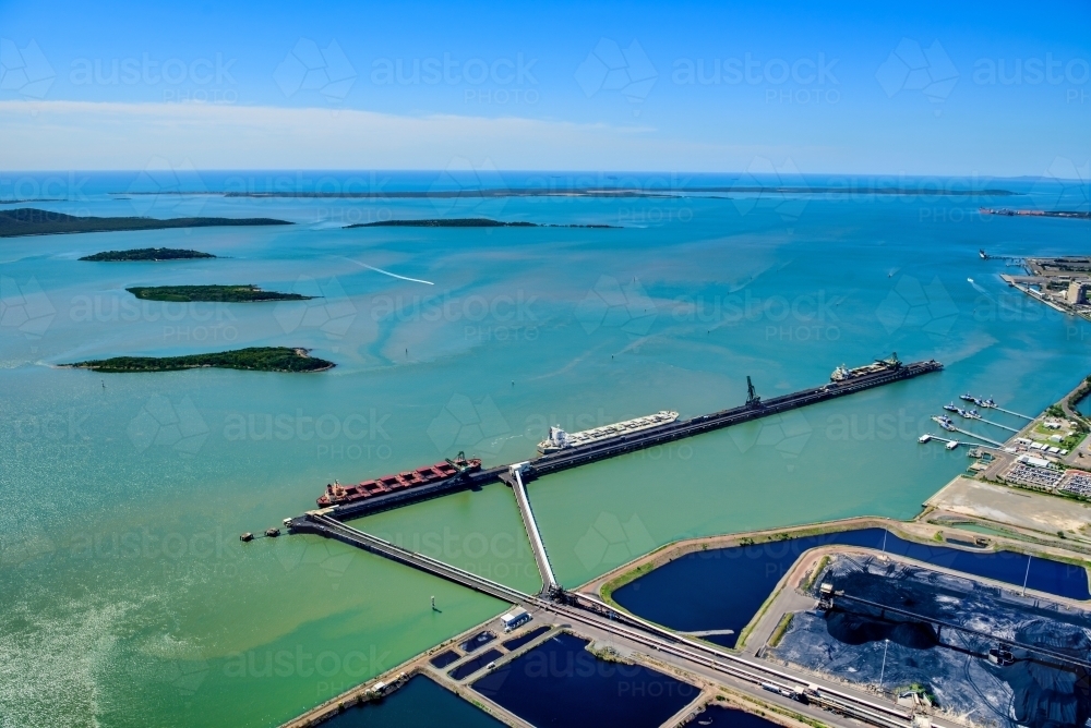 Horizontal shot of RG Tanna coal wharf and sedimentation ponds in Gladstone, Queensland - Australian Stock Image