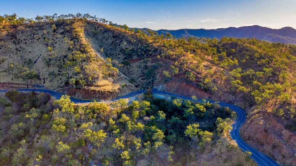 Horizontal shot of road through bushland in Mount Morgan - Australian Stock Image