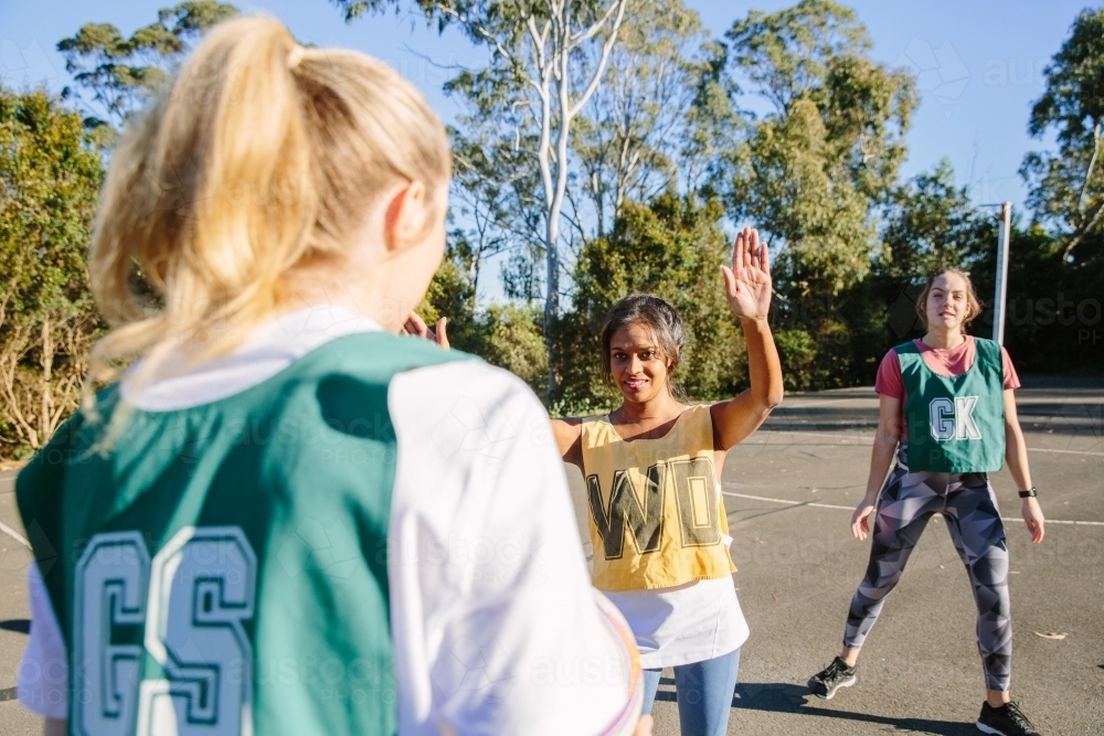 horizontal shot of three young women playing sports on a sunny day - Australian Stock Image