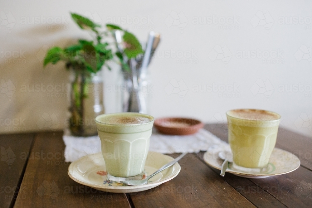 Horizontal shot of two coffees on a wooden table - Australian Stock Image