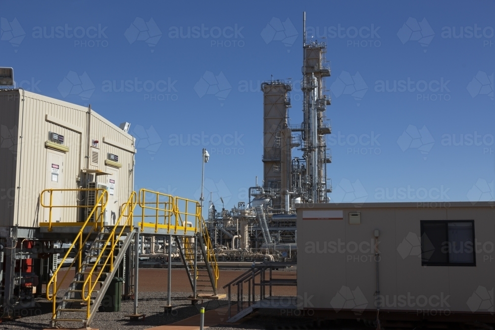Horizontal shot of two small work offices inside an industrial plant. - Australian Stock Image
