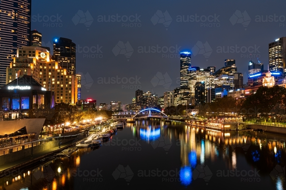 Horizontal shot of Yarra river reflecting the city buildings at night - Australian Stock Image