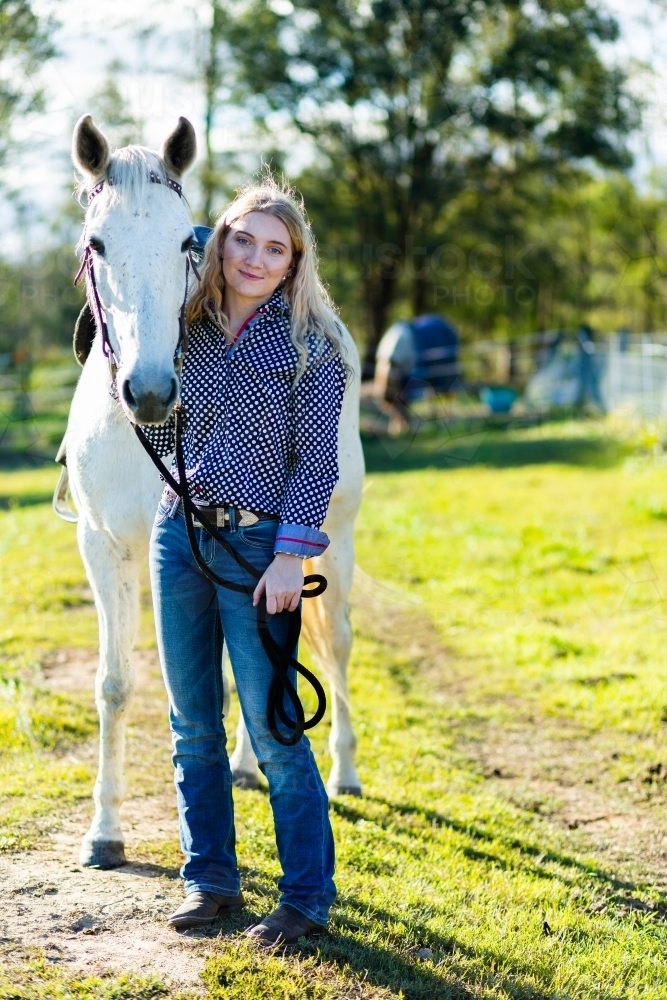 Horse and rider standing together - Australian Stock Image