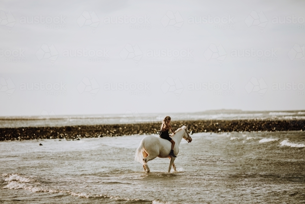 Horse riding on beach - Australian Stock Image
