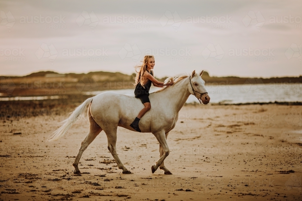 Horse riding on beach - Australian Stock Image