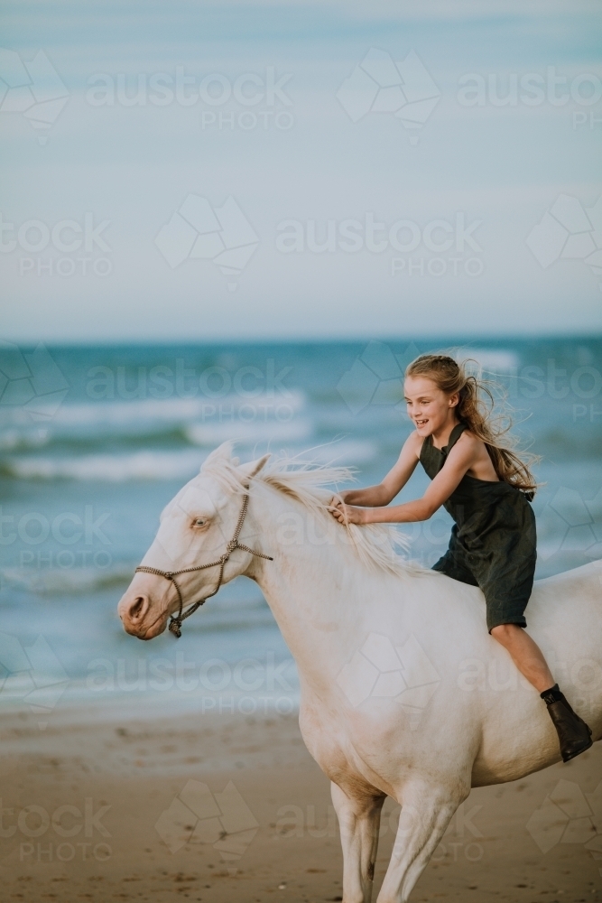 Horse riding on beach - Australian Stock Image