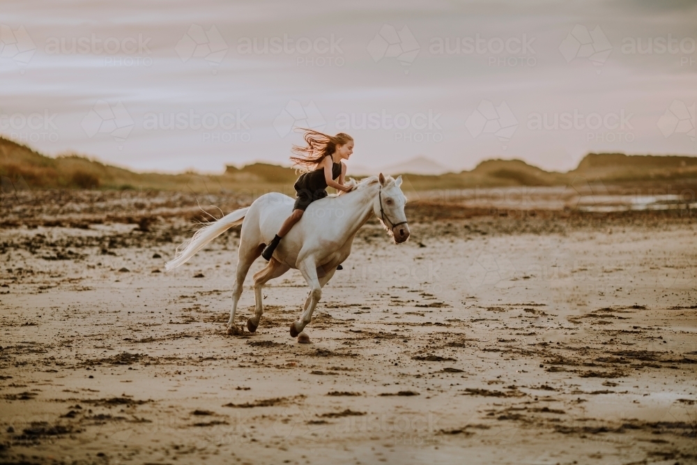 Horse riding on beach - Australian Stock Image