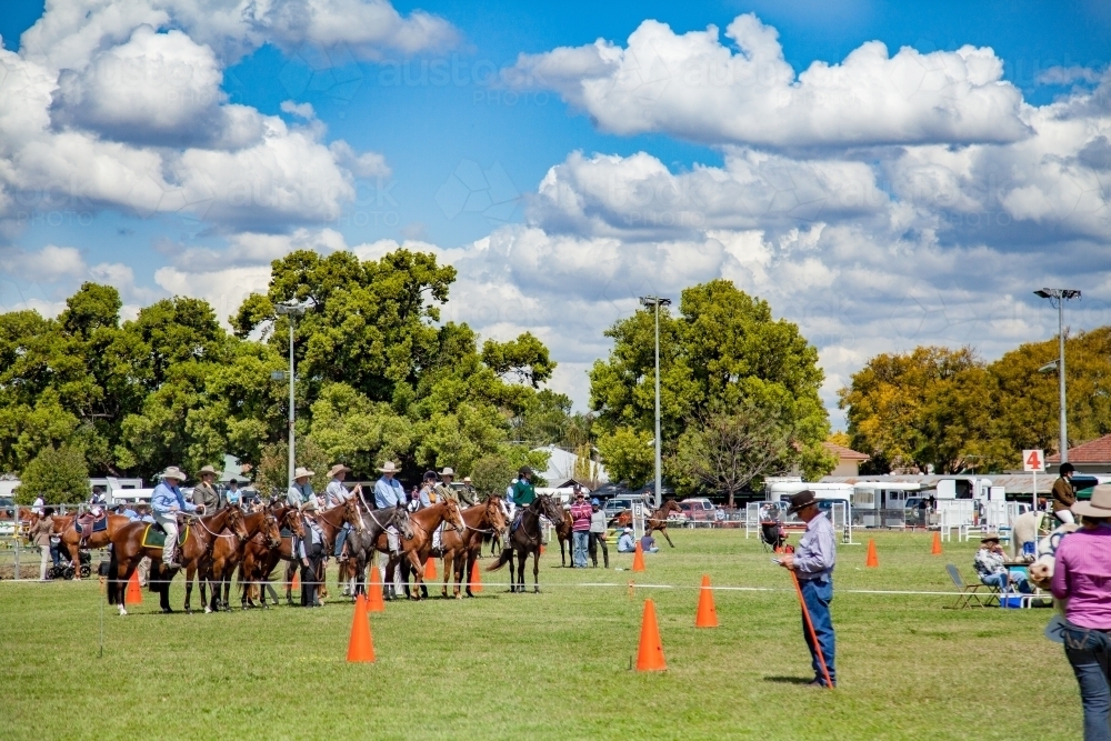 Horses and riders waiting their turn in showground arena - Australian Stock Image
