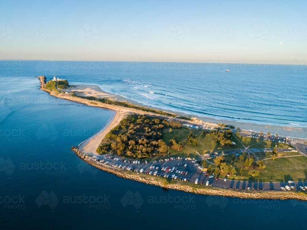 horseshoe beach and headland at sunset with view over ocean - Australian Stock Image