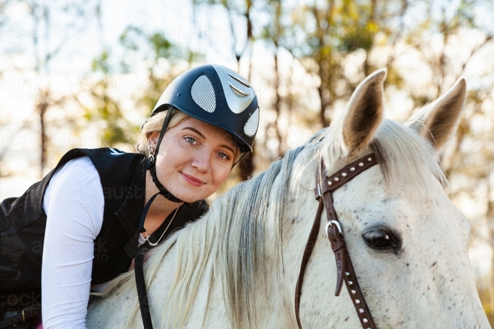 Horsewoman hugging her horse - Australian Stock Image