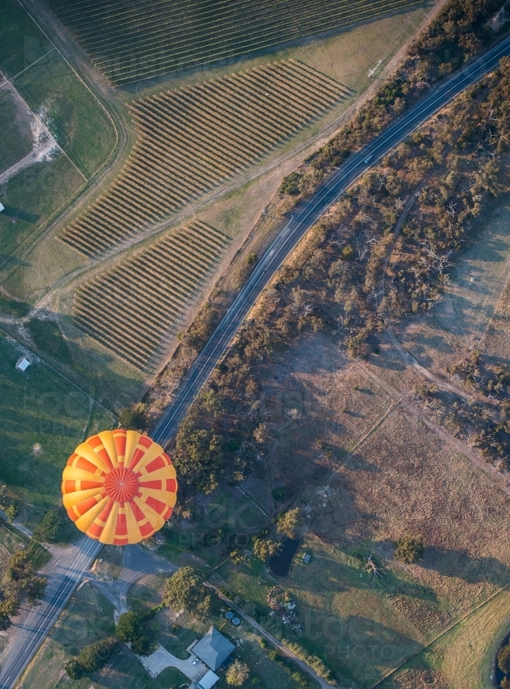 Hot air balloon appears to be travelling on road. - Australian Stock Image