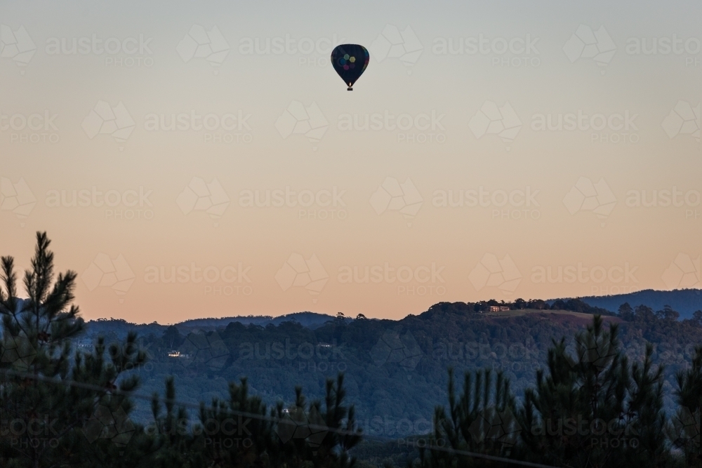 Hot air balloon flying in the early morning - Australian Stock Image
