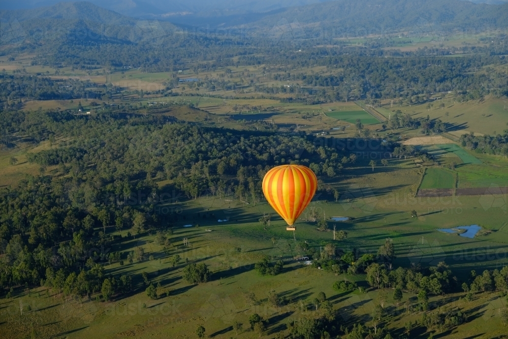 Hot air balloon over the lush green Gold Coast / Scenic Rim hinterland - Australian Stock Image