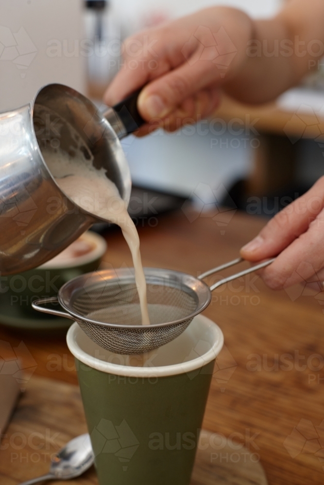 Hot chai latte being prepared by barista - Australian Stock Image