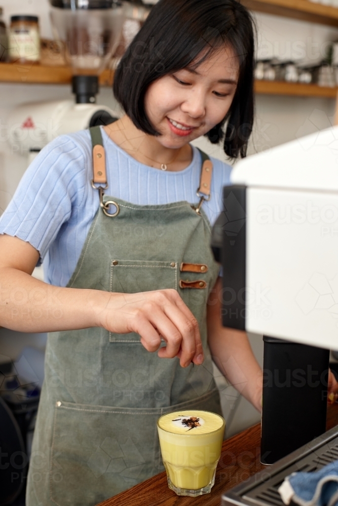 Hot chai latte being prepared by barista - Australian Stock Image