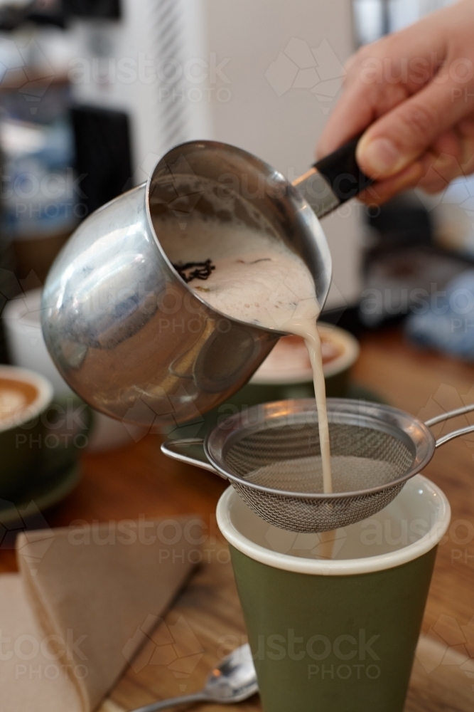 Hot chai latte being served by barista - Australian Stock Image