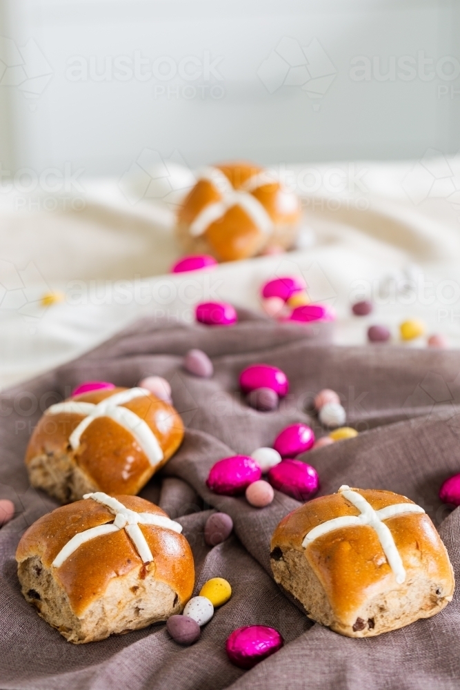 Hot cross bun at Easter with chocolate eggs - Australian Stock Image