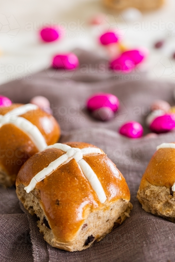 Hot cross bun at Easter with chocolate eggs - Australian Stock Image