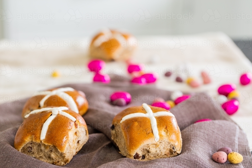 Hot cross bun at Easter with chocolate eggs - Australian Stock Image