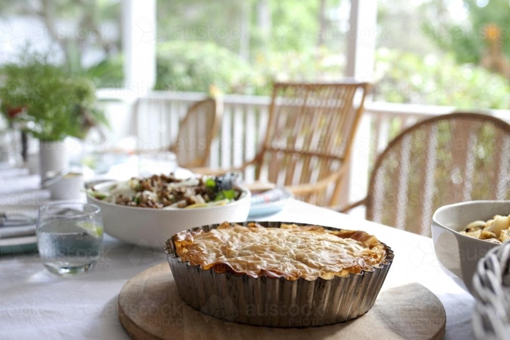 Hot pie and salad on a lunch table - Australian Stock Image