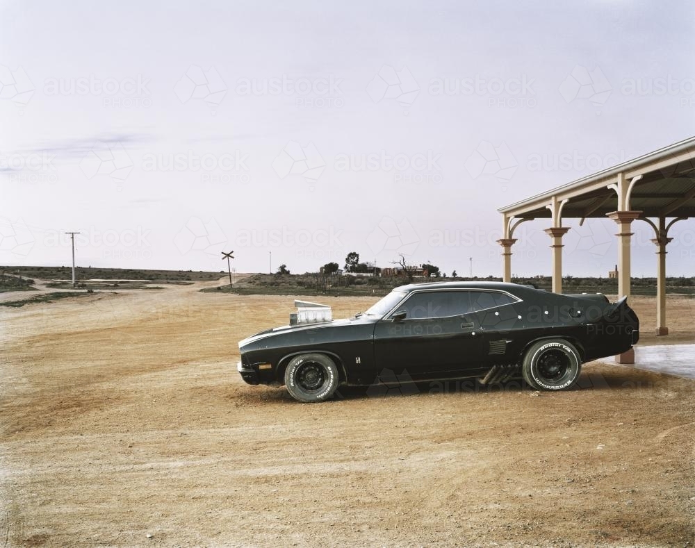Hotted up black car in remote outback town - Australian Stock Image