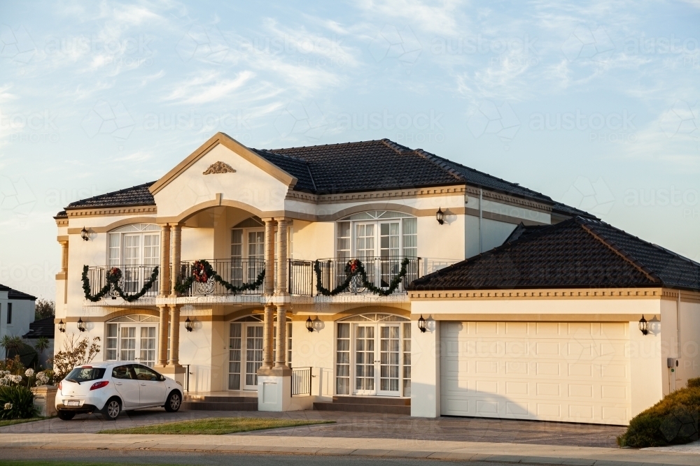 House at sunset with Christmas decorations on balcony - Australian Stock Image