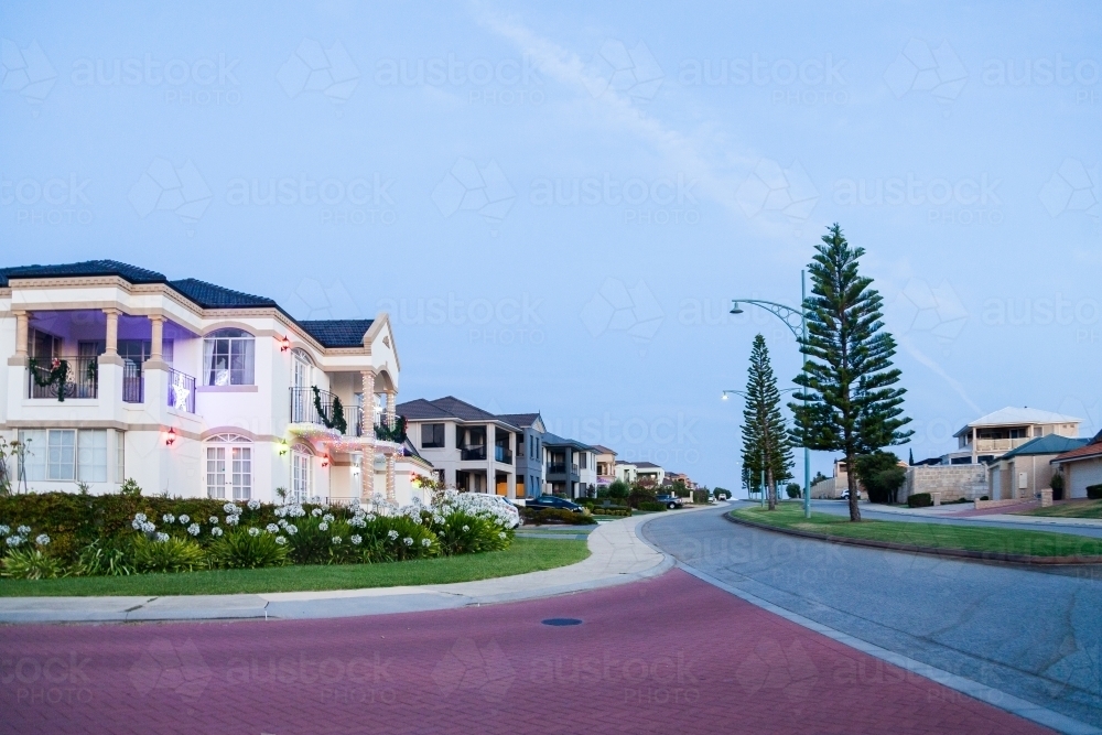 House on street corner at dusk with Christmas lights and decorations - Australian Stock Image