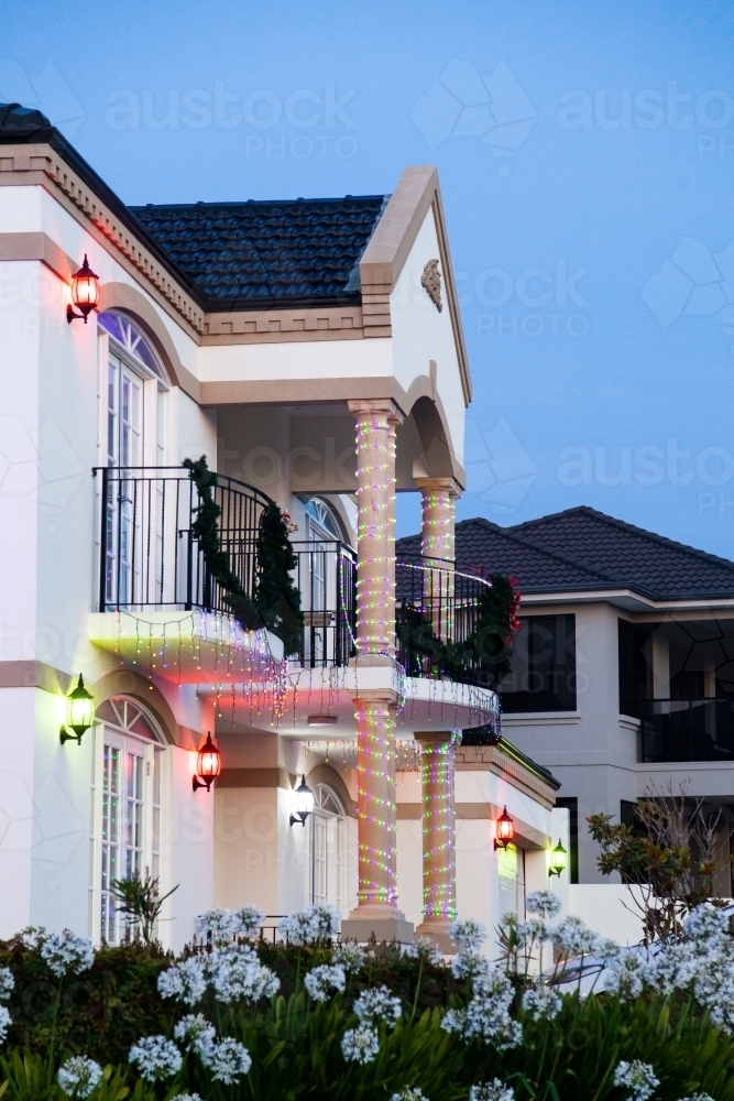 House on street corner at dusk with Christmas lights and decorations - Australian Stock Image