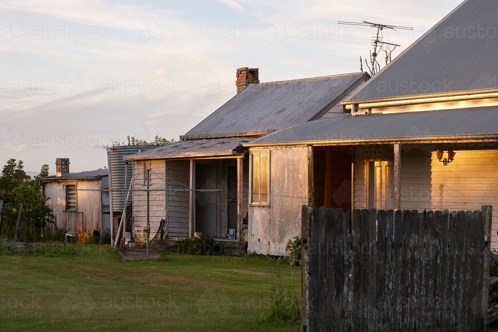 Image of House with a lawn during sunrise/sunset - Austockphoto